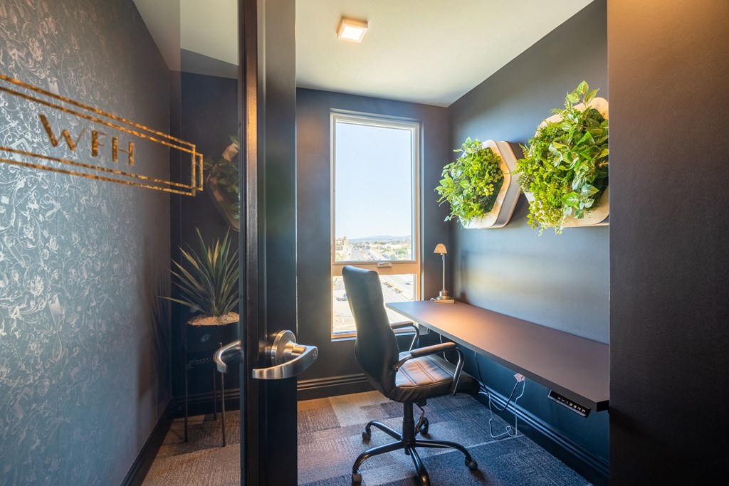 a workspace with a desk and a chair and a window