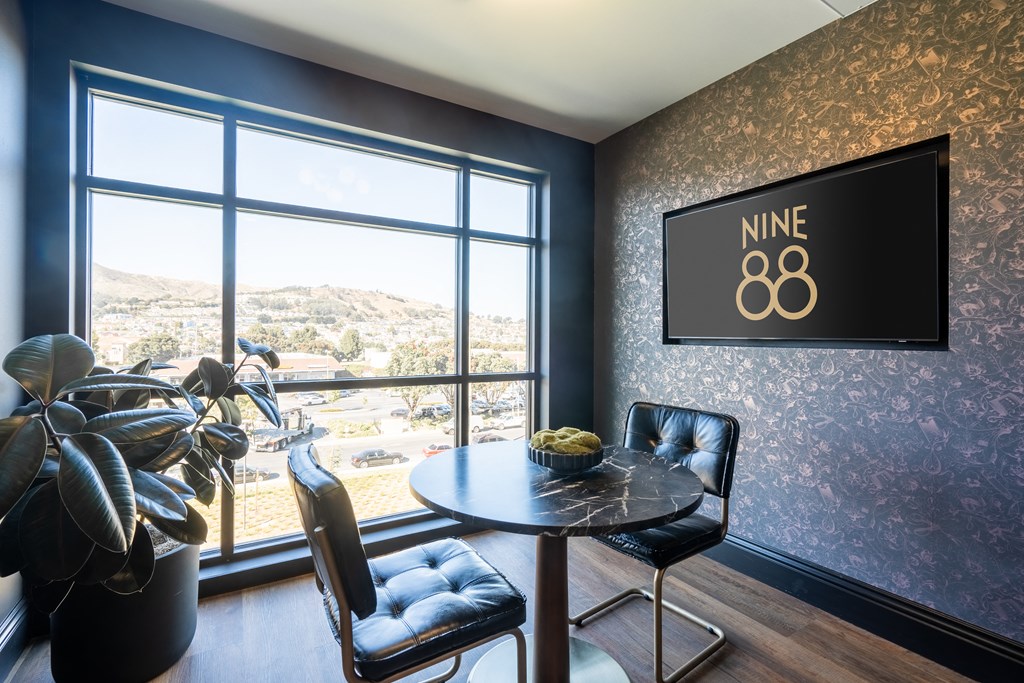 a dining room with a table and chairs and a large window
