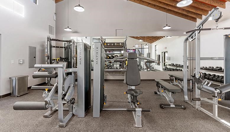 a gym with a lot of exercise equipment in it