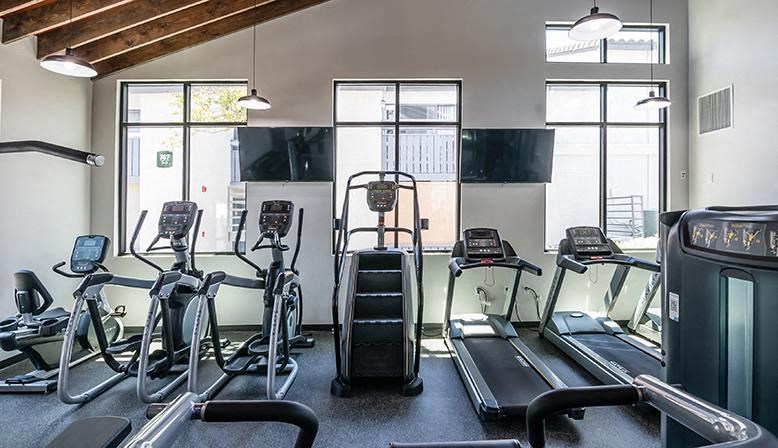 a gym with various pieces of exercise equipment