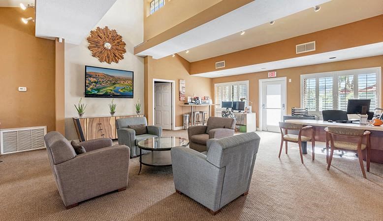 a living room and dining room with chairs and a table