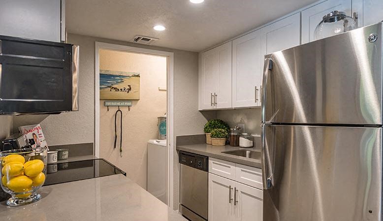 a kitchen with stainless steel appliances and white cabinets
