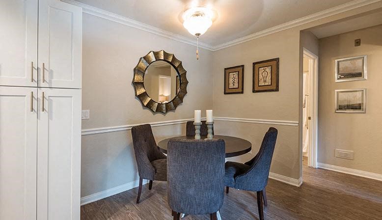 a dining room with a table and chairs