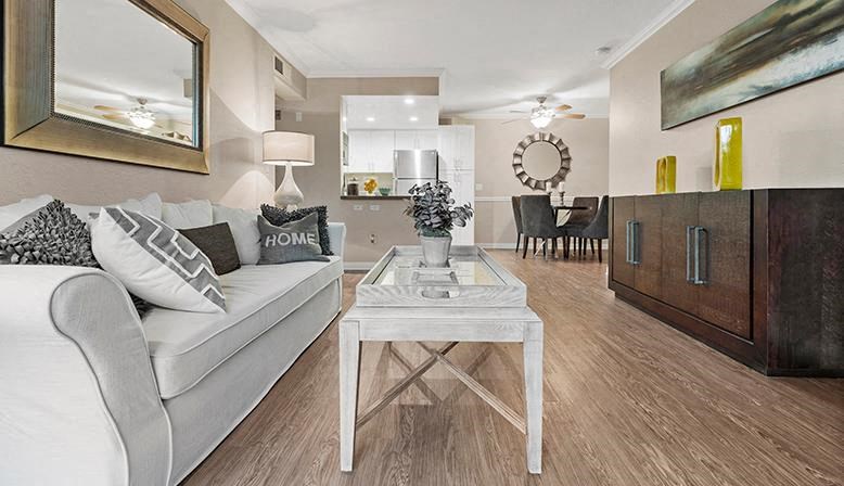a living room with a white couch and a table