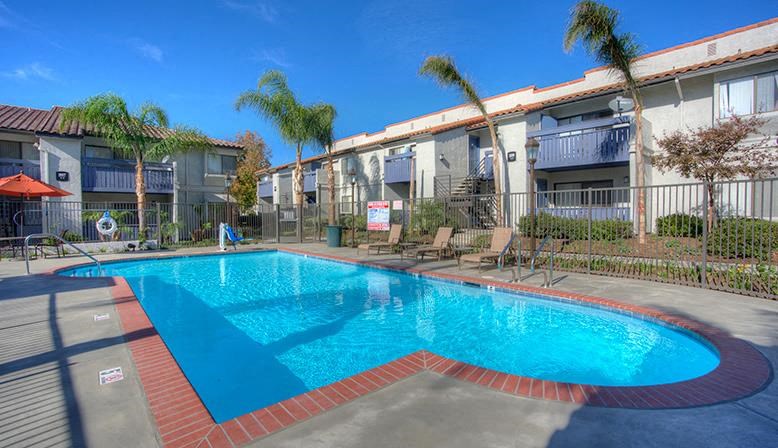 a large blue pool in the middle of an apartment building