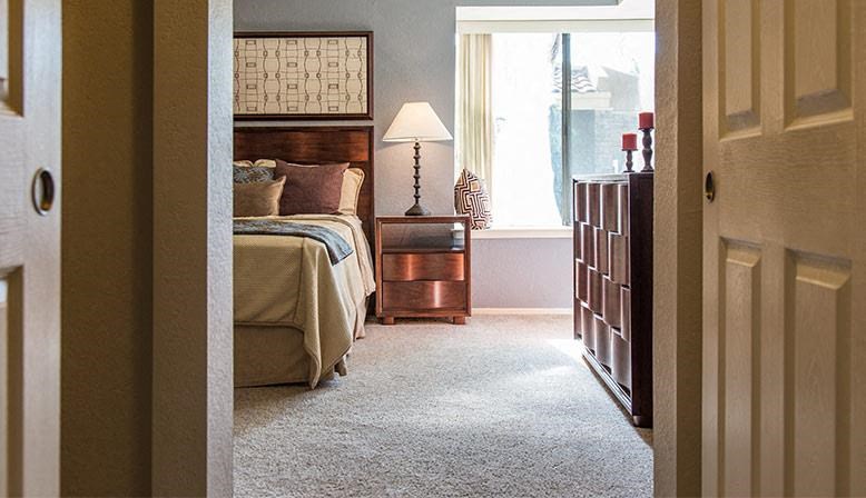 a bedroom with a bed and a dresser