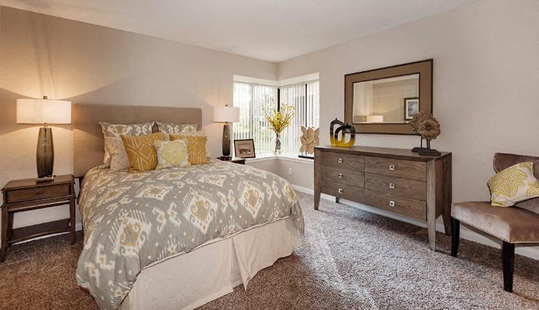 a bedroom with a bed and a dresser