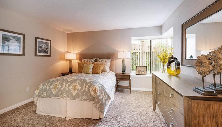 a bedroom with a bed and a mirror