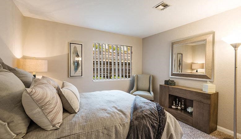 a bedroom with a large bed and a mirror