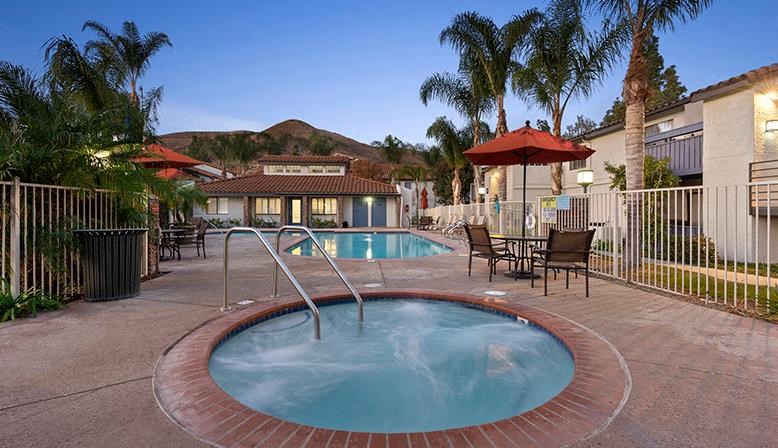 a hot tub in the middle of a resort pool