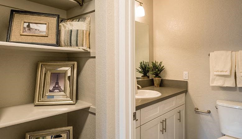 a bathroom with a toilet and a sink and a mirror