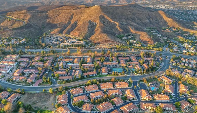 an aerial view of a city with mountains