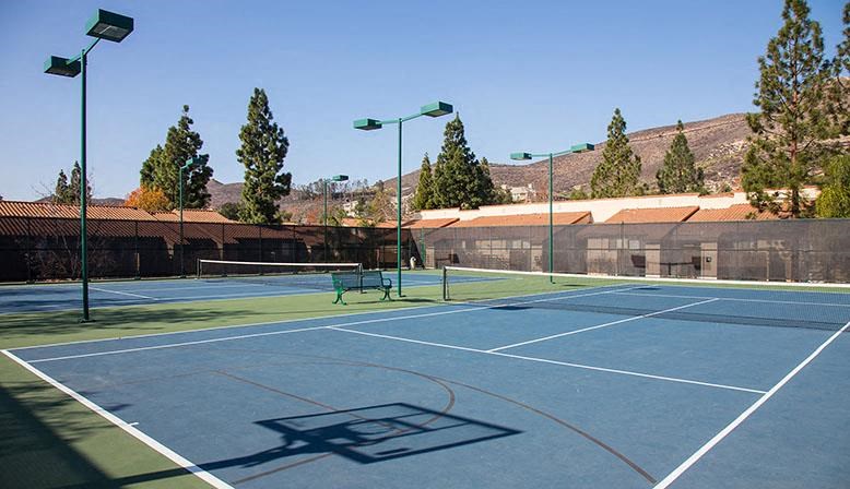 a tennis court with a bench on it