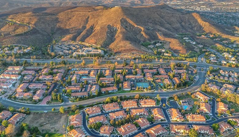 an aerial view of a city with mountains
