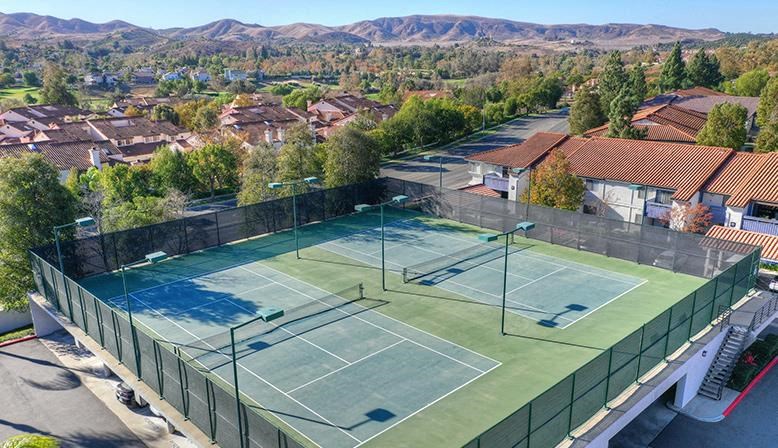 an aerial view of a tennis court on top of a house