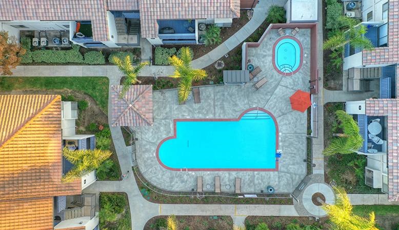 a backyard with a swimming pool in the middle of a house