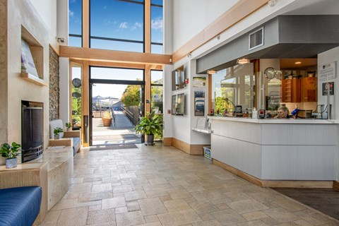 A reception area with a blue couch and a reception desk.