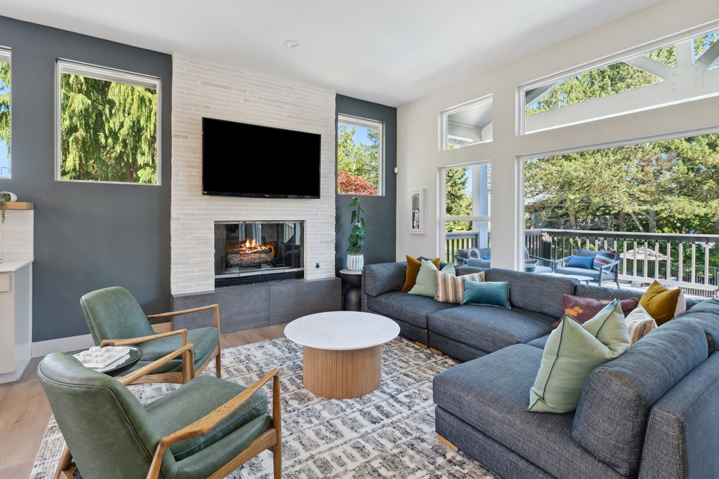 a living room with couches and chairs and a fireplace
