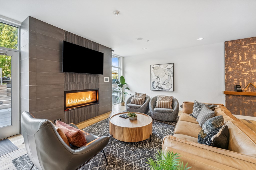 a living room with couches and chairs and a fireplace
