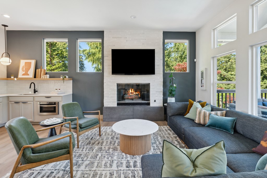 a living room with couches and chairs and a fireplace