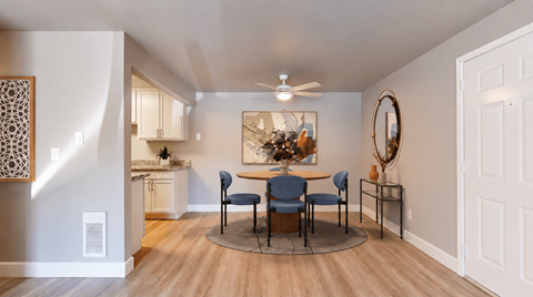 A dining room with a round table and chairs.