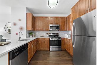 a kitchen with stainless steel appliances and wooden cabinets