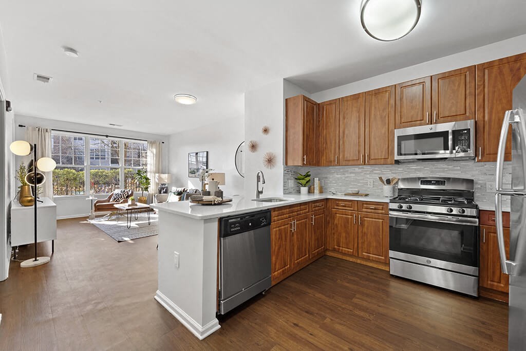 a kitchen with wooden cabinets and stainless steel appliances