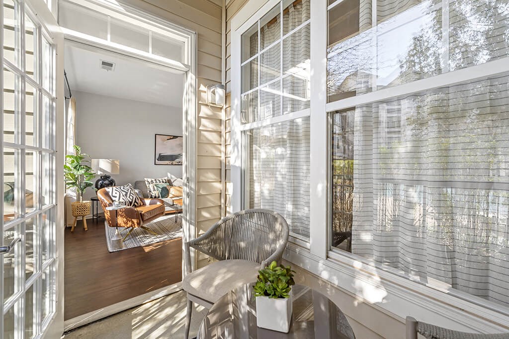 a porch with a table and chairs and a living room
