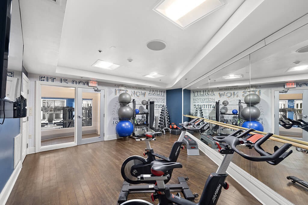 a gym with weights and exercise equipment and mirrors