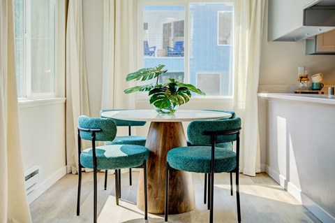 a small dining room with a table and three chairs