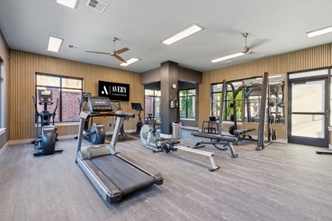 a gym with weights and other exercise equipment and windows