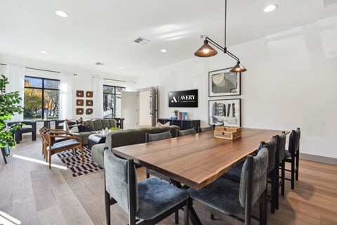 a dining room and living room with a wooden table and chairs