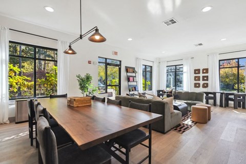a dining room and living room with a table and chairs