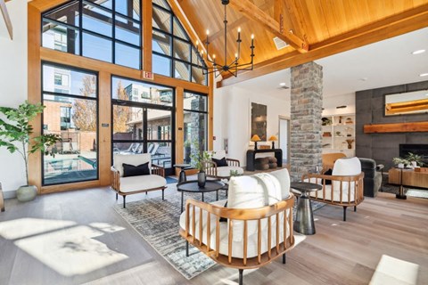 a living room with a fireplace and large glass doors