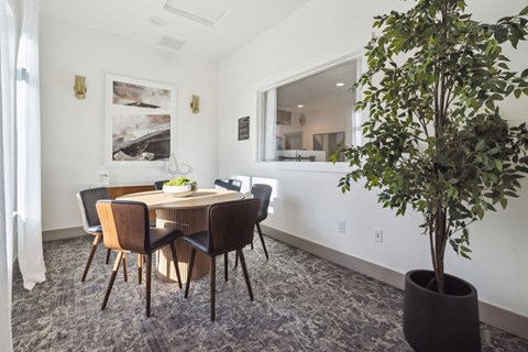 a dining room with a table and chairs