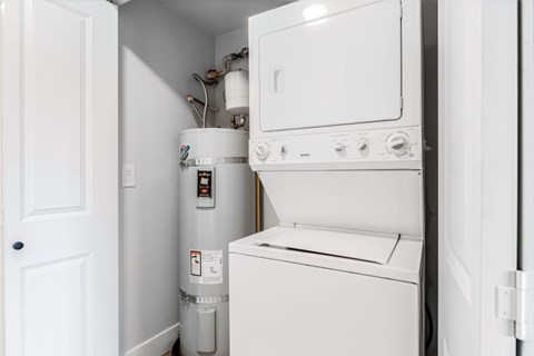 A white washing machine and dryer in a small laundry room.