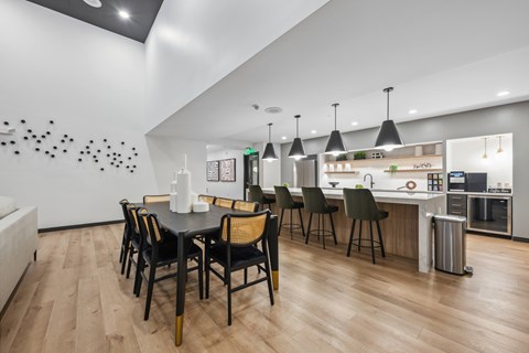 a dining room with a table and chairs and a kitchen