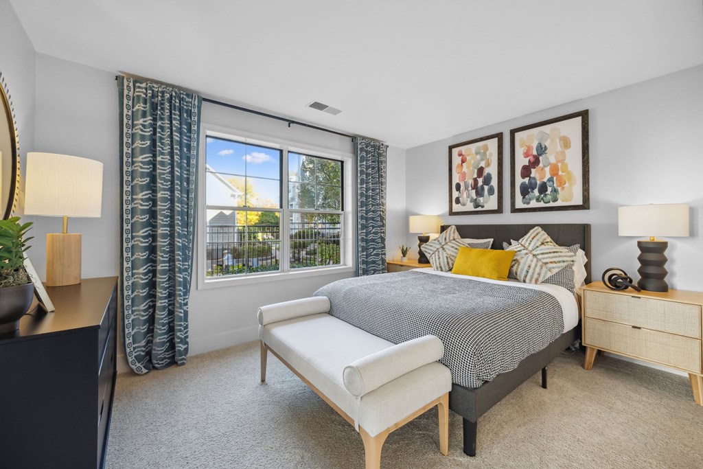 a bedroom with a bed and a large window