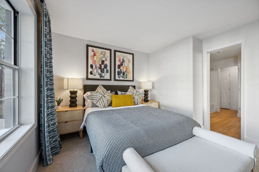 a bedroom with a large bed and a window