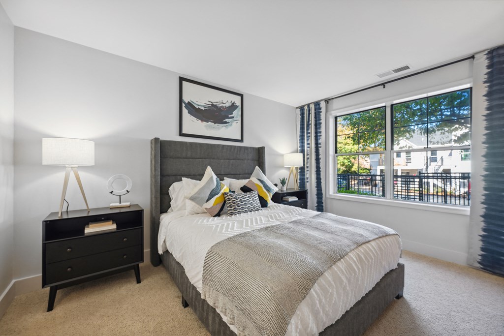 a bedroom with a bed and a large window