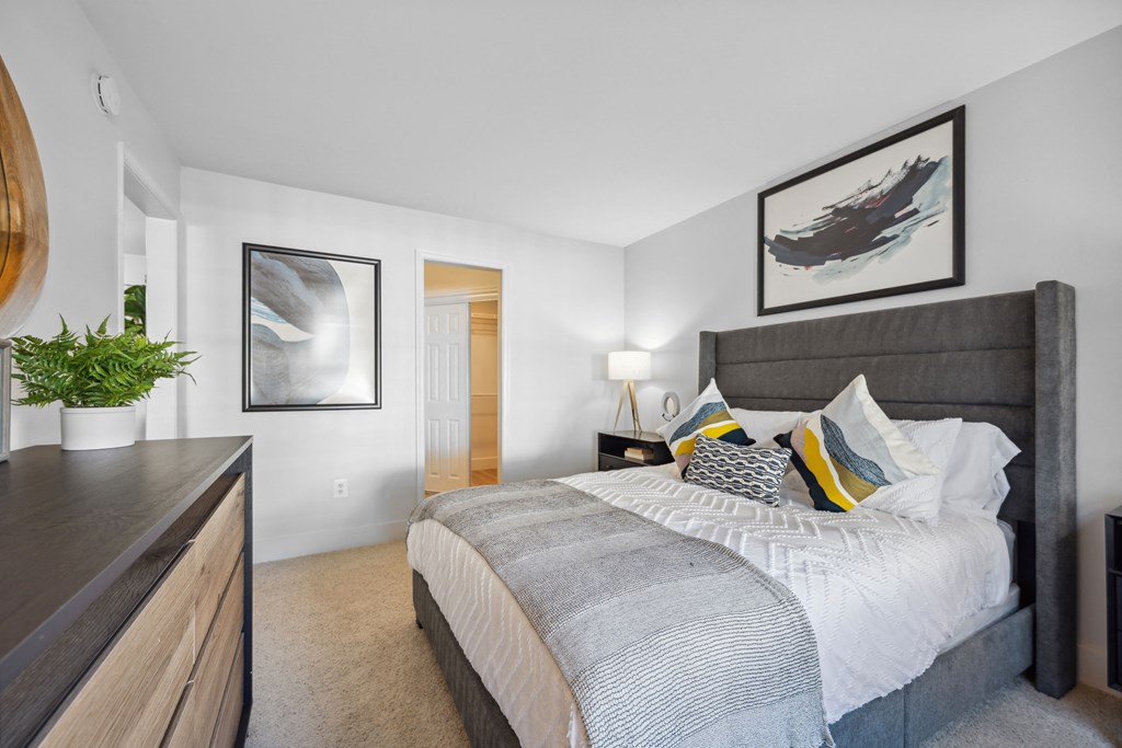 a bedroom with a large bed and a dresser