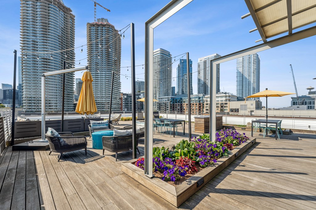 a roof top patio with a view of the city