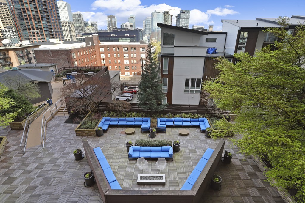 an aerial view of a courtyard with blue lounge chairs