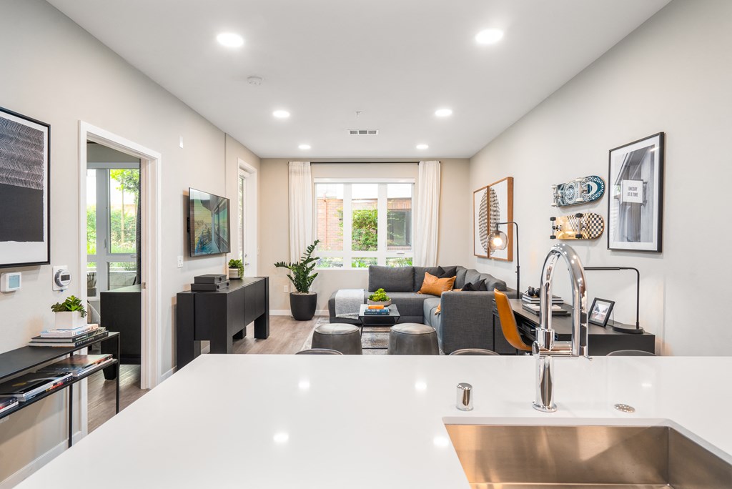 a living room with a kitchen and a couch and a table