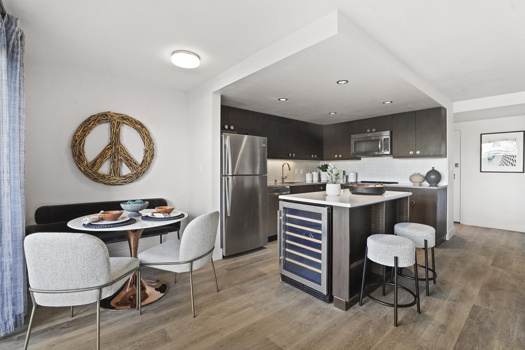 a kitchen and dining area with a table and chairs