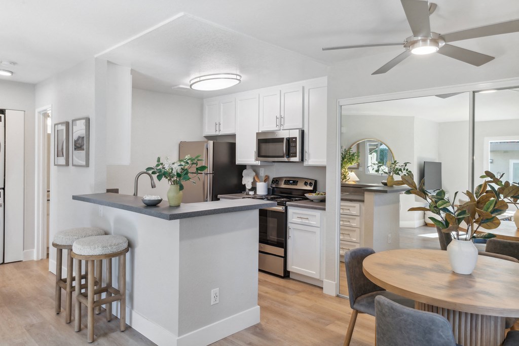 an open kitchen and dining area with a table and chairs