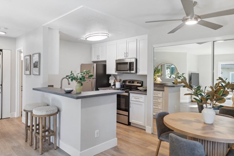 an open kitchen and dining area with a table and chairs