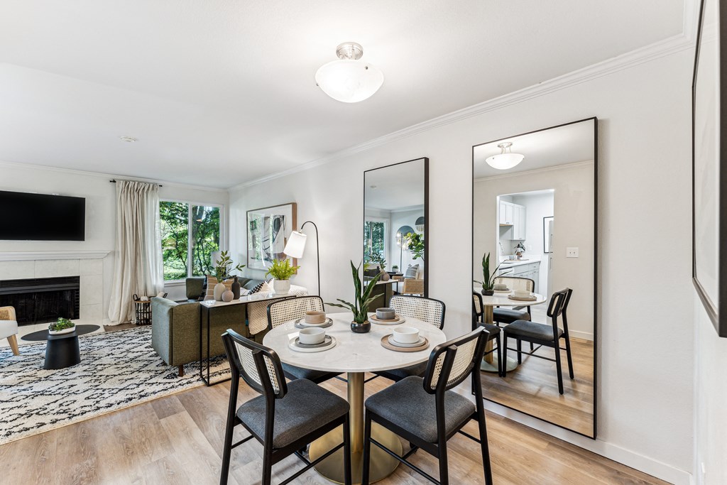 a living room and dining room with a table and chairs