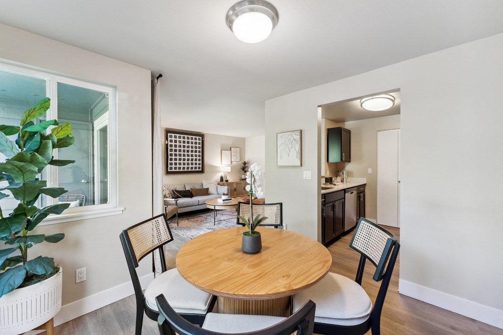 a dining room and living room with a table and chairs