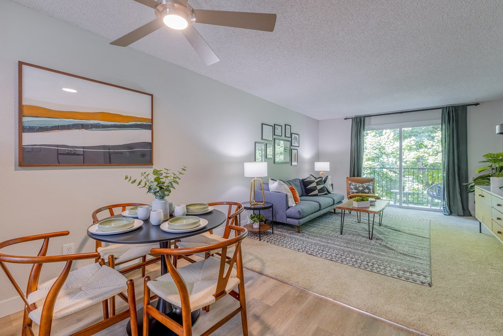a living room and dining room with a table and chairs